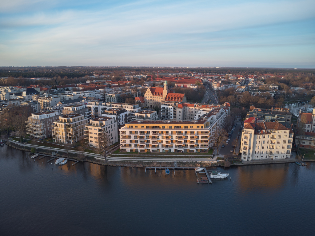 Aerial shot of buildings during sunset by the Spree river in Köpenick, Berlin.