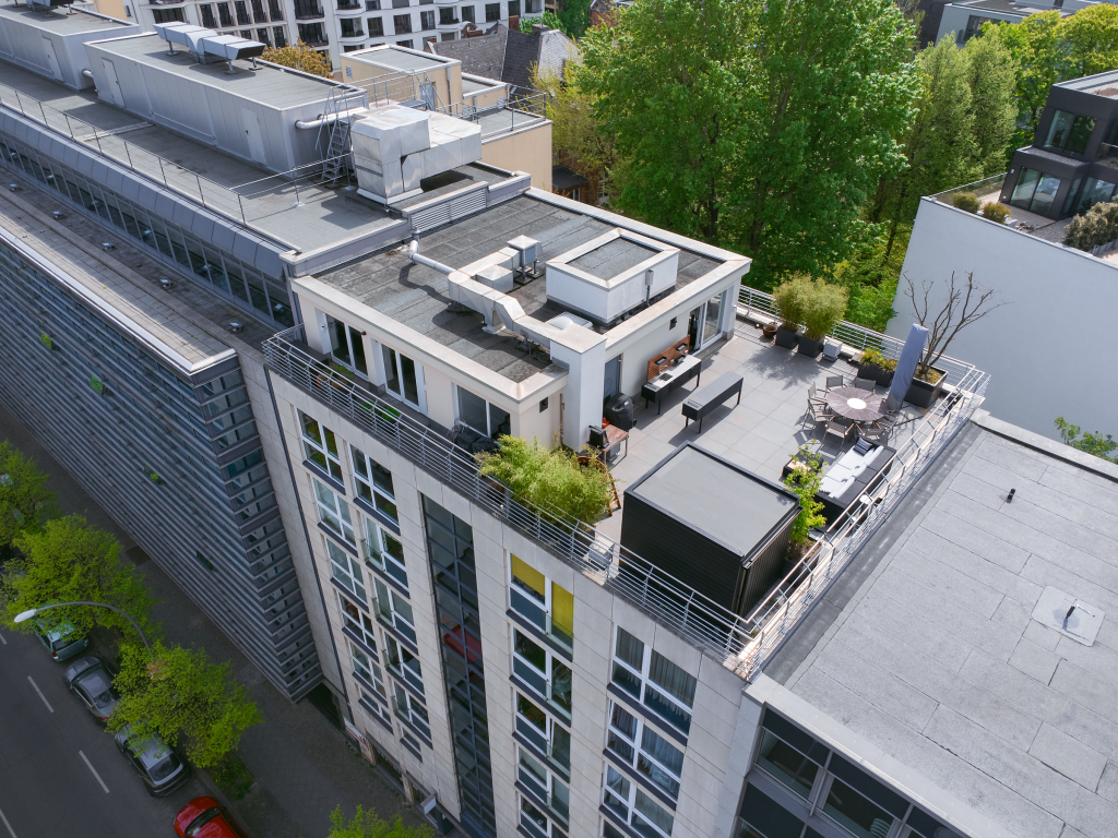 Top-down view of a rooftop apartment with a large open terrace in Wilmersdorf, Berlin.