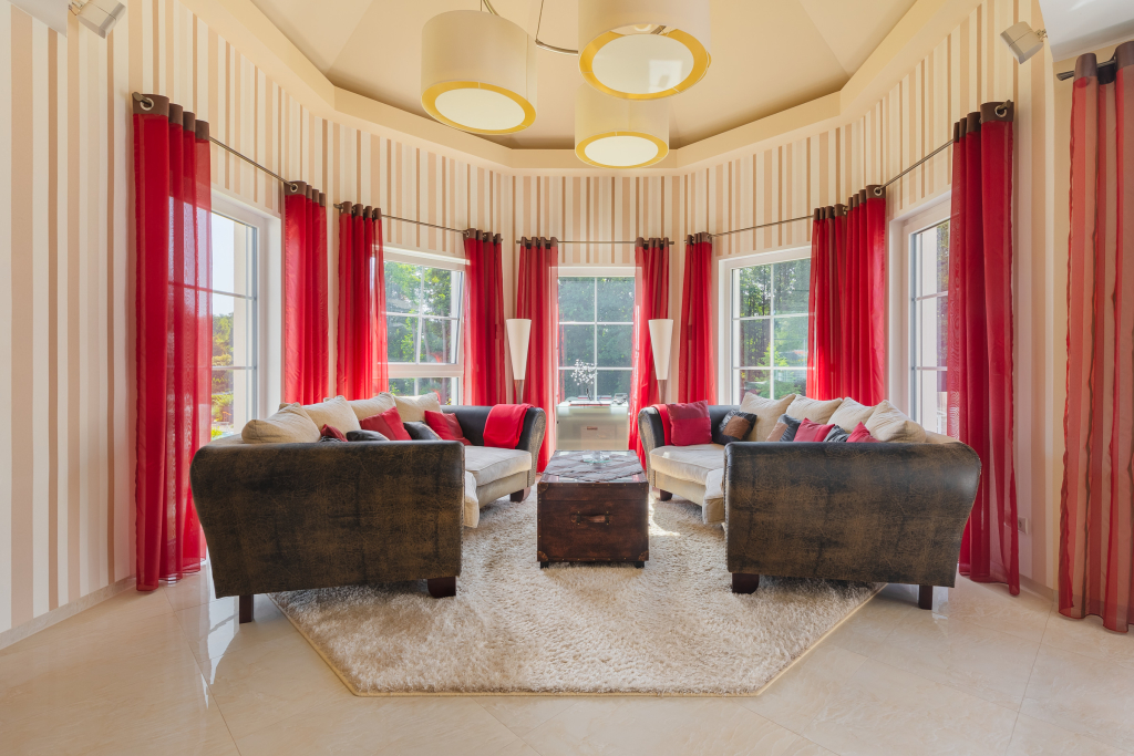 Bright lounging area with two large sofas and a coffer coffee table in a compass window of considerable size.