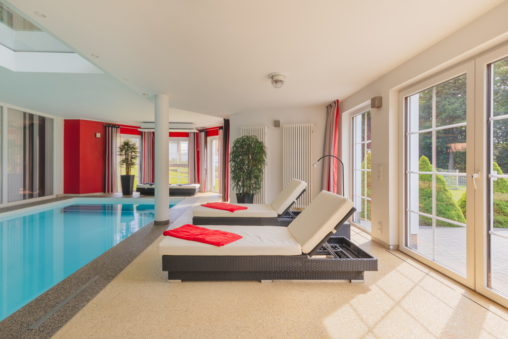 Comfortable deckchairs by the interior pool of a villa in Birkenwerder, Brandenburg.