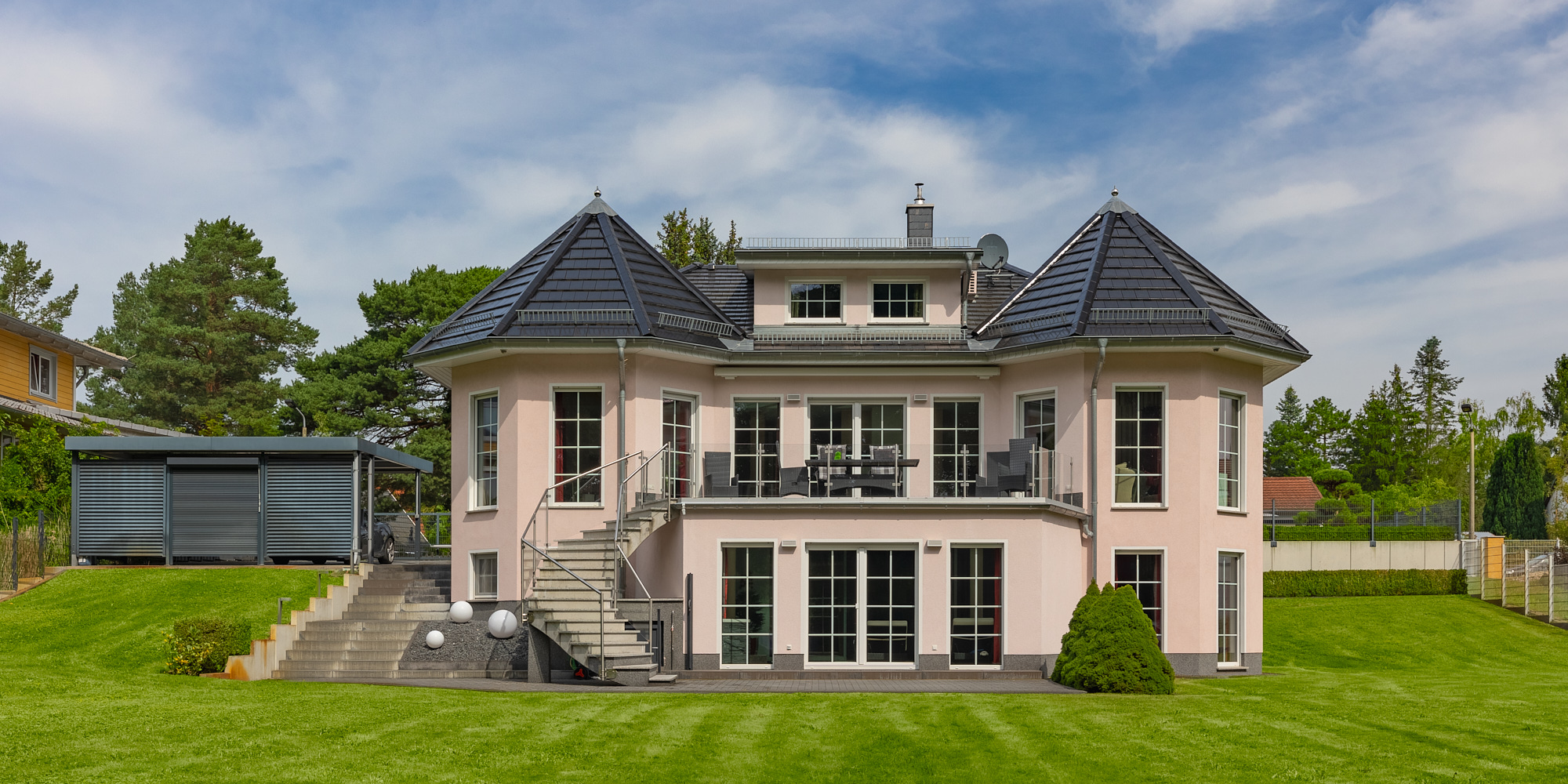 Luxuriöse Villa mit gepflegten Rasenflächen, umgeben von Bäumen in der Nähe von Birkenwerder, Berlin.