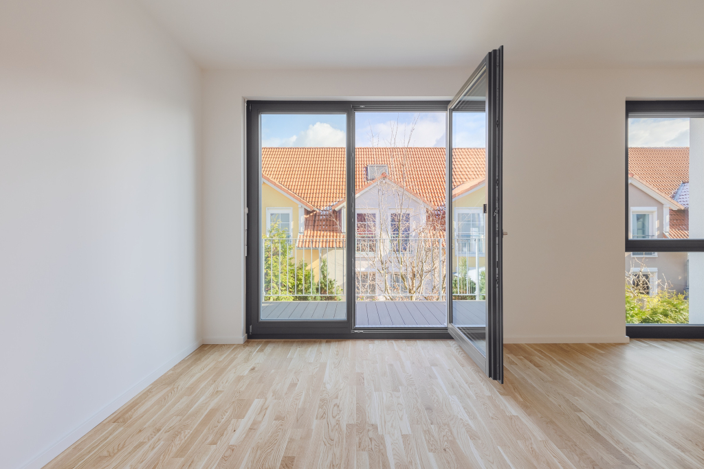 Bright and naturally lit room with a double glazed door leading out to an open balcony.