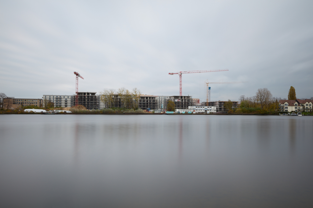 Bright long exposure photograph of a construction site, showing clear machinery details but slightly softened by the overcast light.