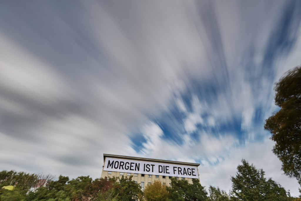 Fast moving clouds in a long exposure above the Berghain night club in Berlin with the installation Tomorrow is the question by the artist Rirkrit Tiravanija.