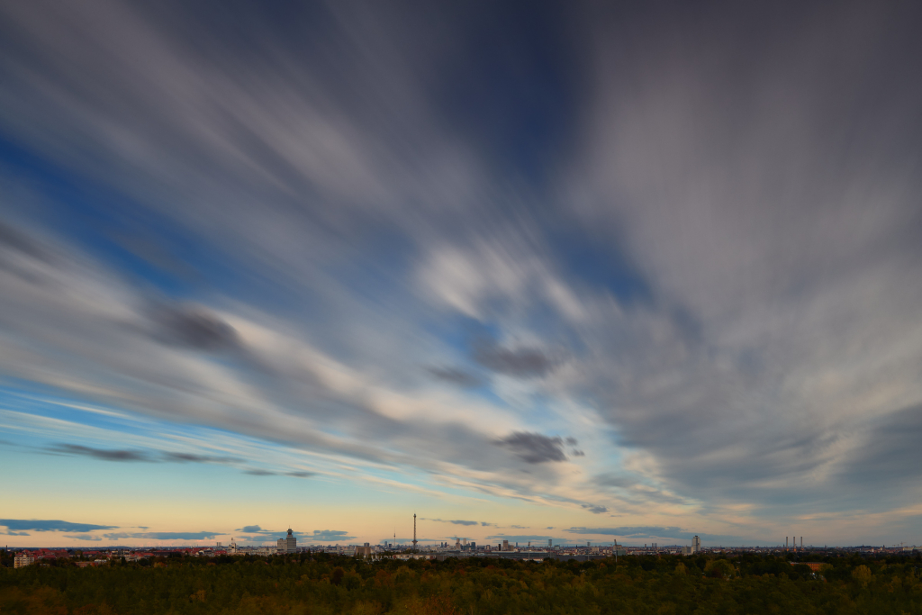 Fast moving clouds captured by a long exposure image above Berlin, seen from the Drachenberg hill in Charlottenburg.