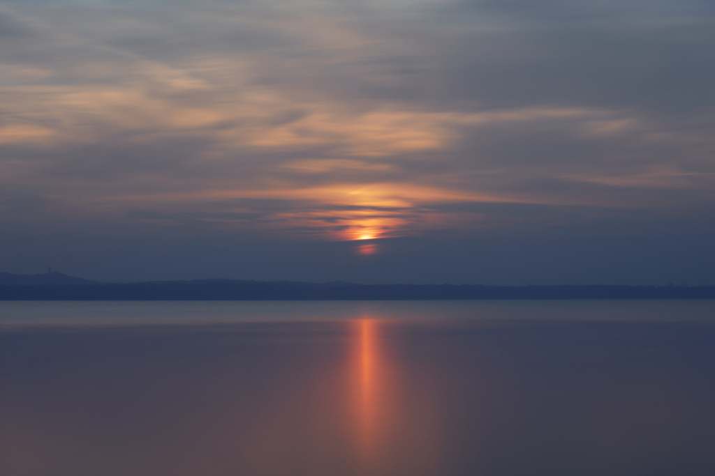 35-second long exposure over the Großer Müggelsee, Berlin, at sunset, with a warm orange reflection on the water, blending into deep blues.