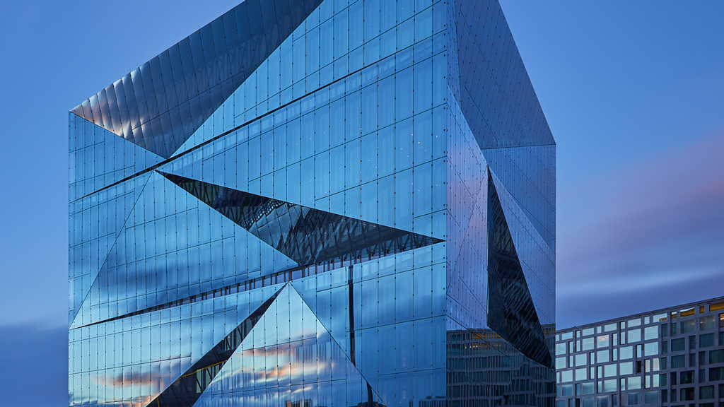 Modern geometry meets morning light – Cube Berlin at sunrise in long exposure.