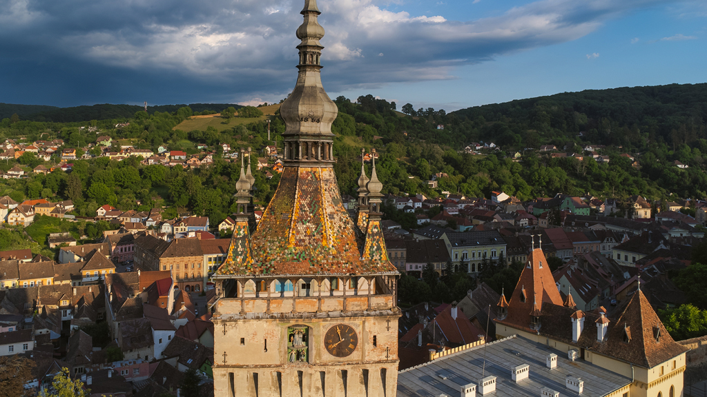 Historic Clock Tower in Sighisoara, Romania, captured from above on a clear sunny day.
