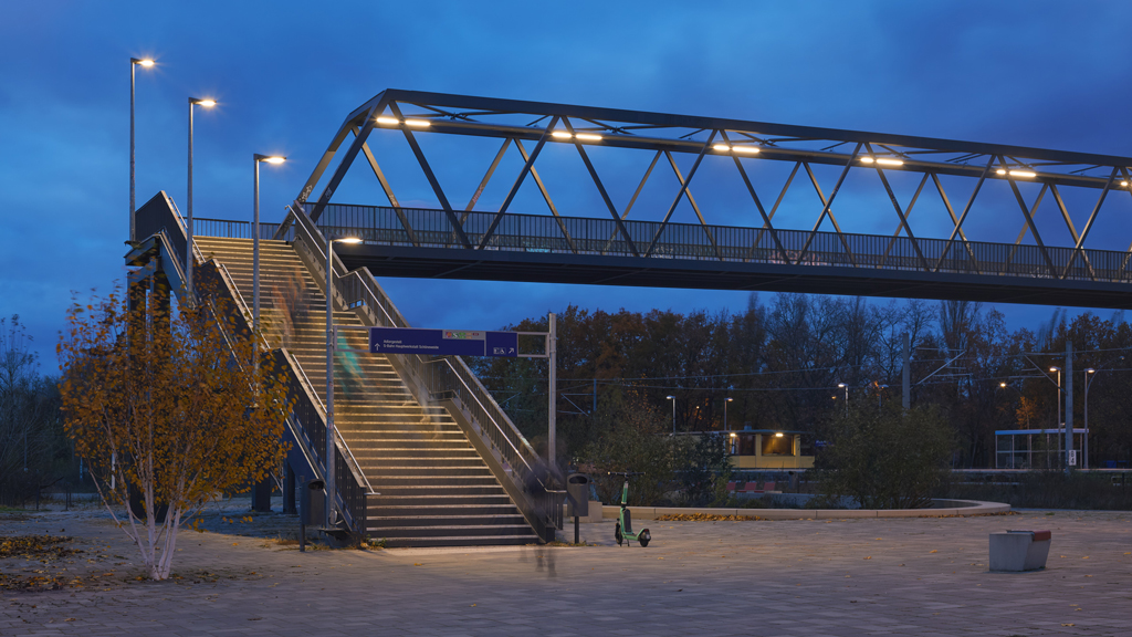 Evening light highlights pedestrian bridge and stairs in Johannisthal, Berlin.