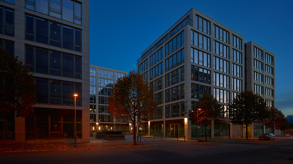 Sleek office architecture on the Zalando Campus near East Side Gallery in Berlin during dusk.